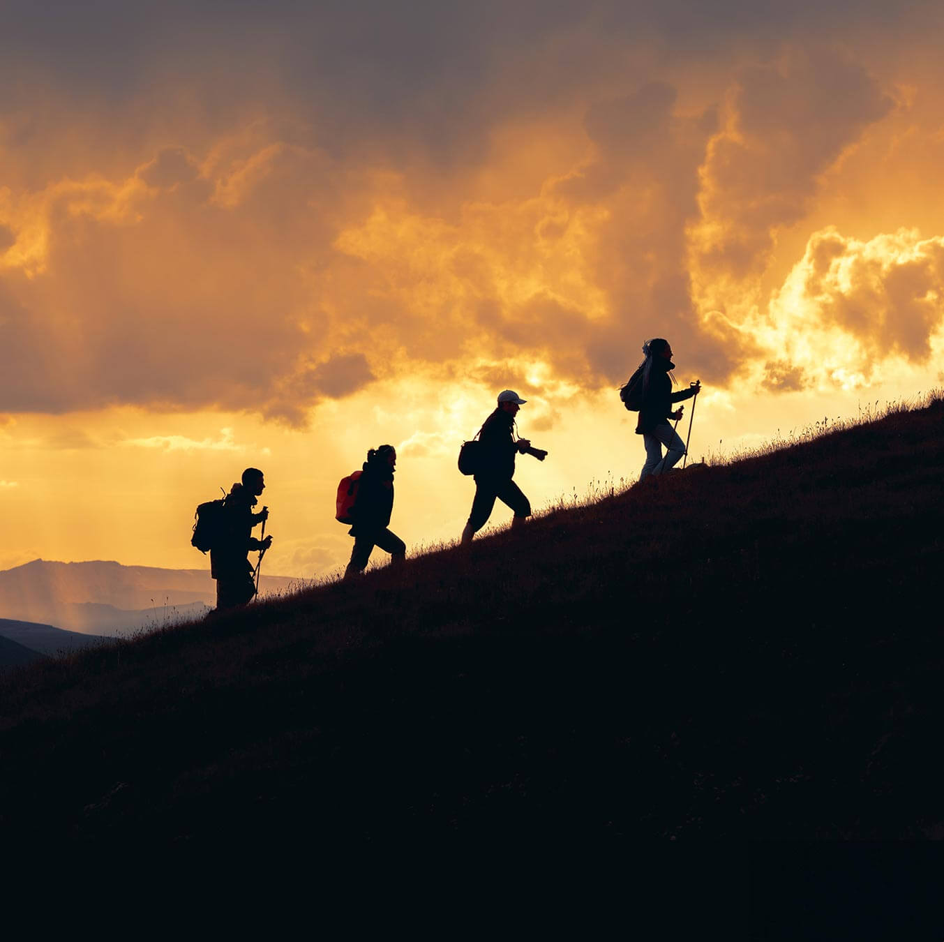 teamwork - hiking up a mountainside